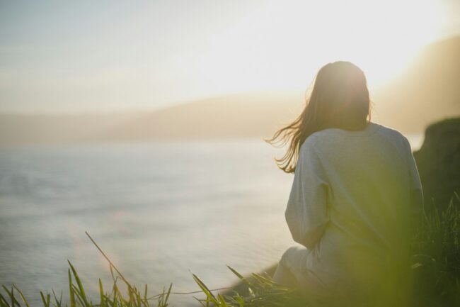 trauma stage recovery journey person looking toward bright horizon