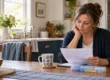 Caregiver burnout: a caregiver reviews a care schedule beside a medication organizer at a kitchen table