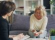 Adult client seated and speaking with a therapist during a private trauma counseling session