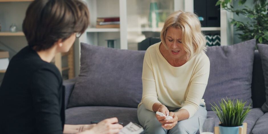 the-complete-guide-to-childhood-trauma-therapy-for-adults-image Adult client seated and speaking with a therapist during a private trauma counseling session